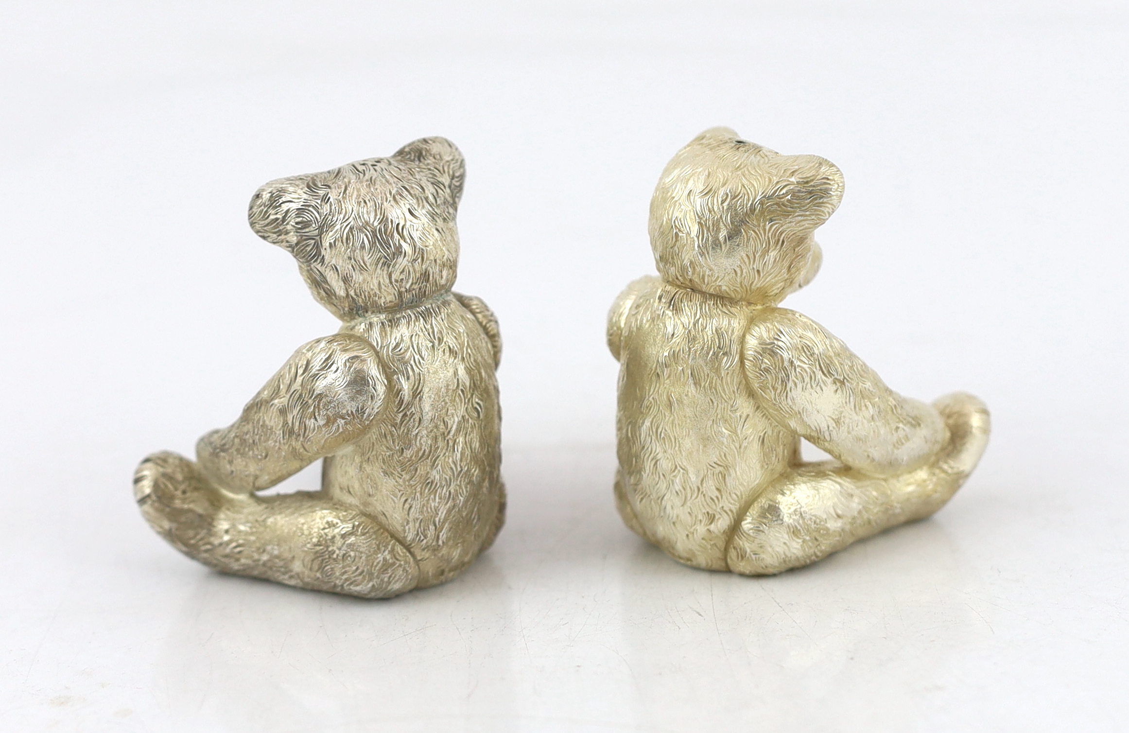 A pair of Elizabeth II cast silver novelty condiments, each modelled as a seated teddy bear